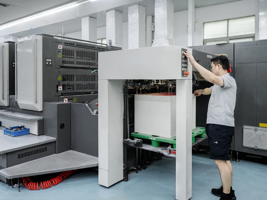Technician operating an offset printing press