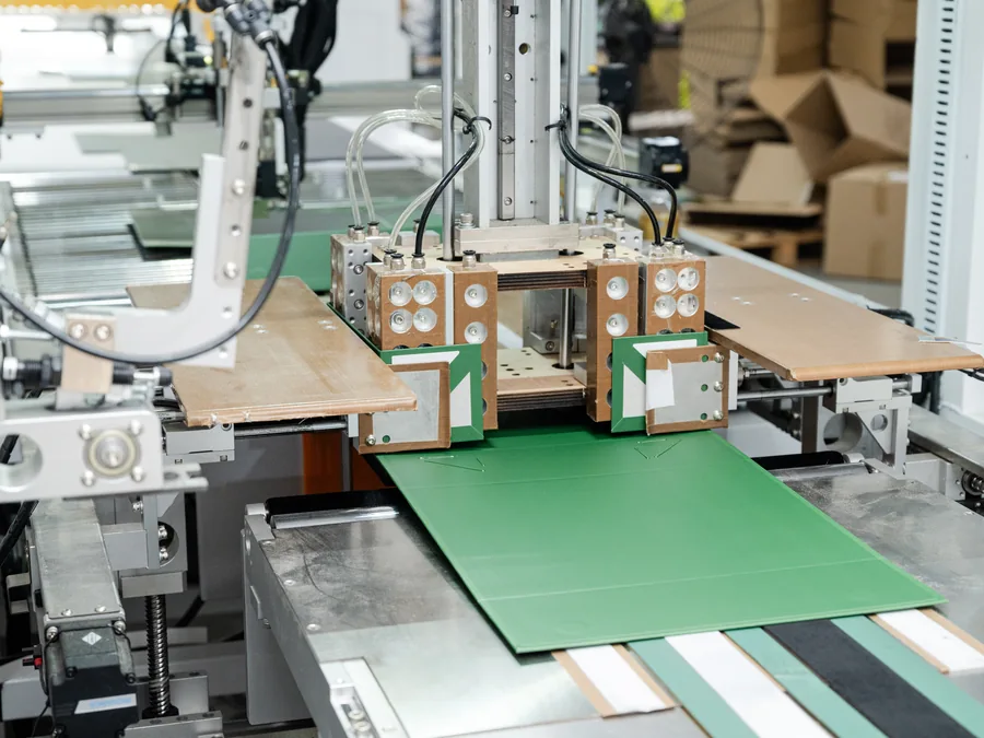 Paper boxes moving through assembly equipment
