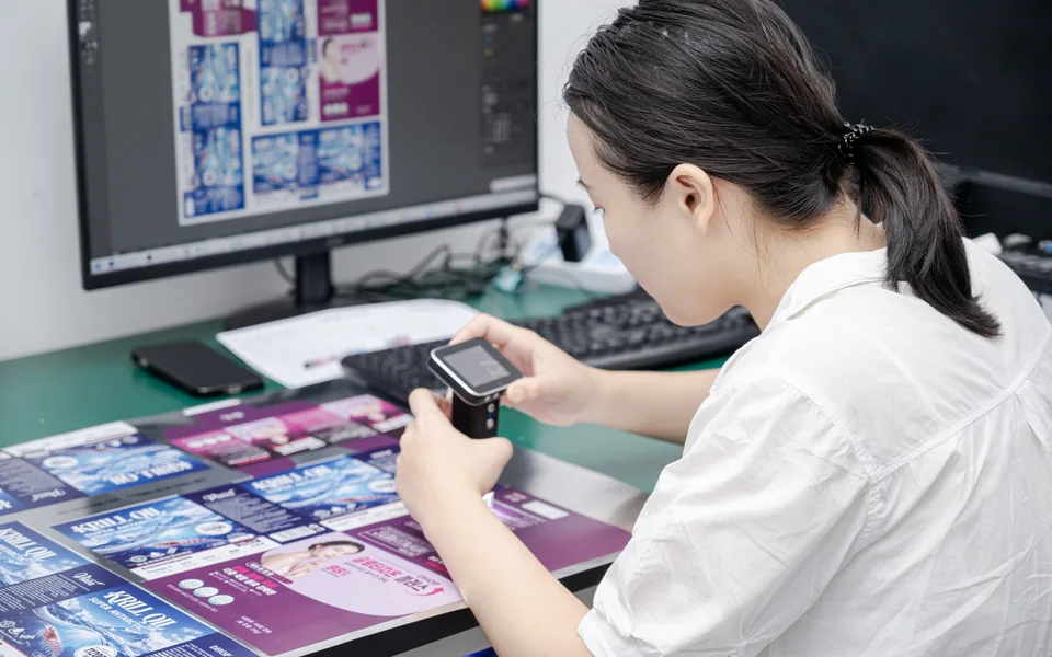 Employee checking print color consistency