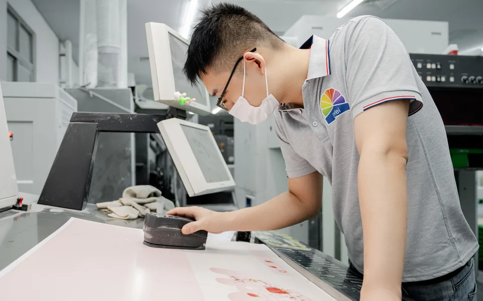 Packaging technician checking production consistency